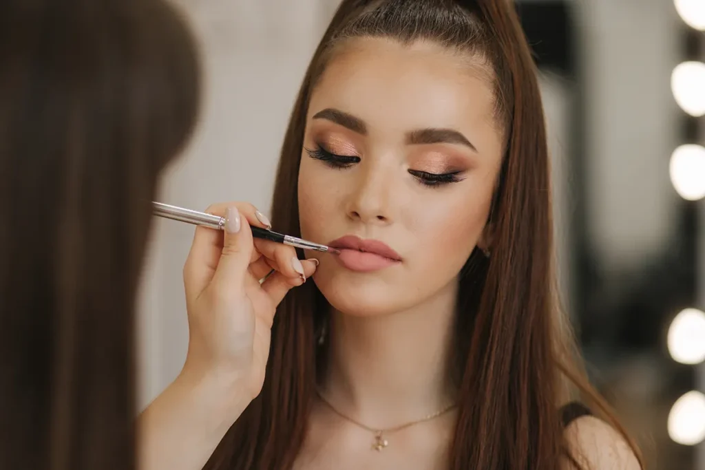 make up artist with brown haired model
