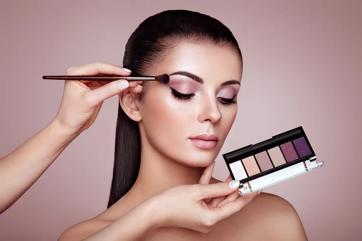 make up artist with pink palette